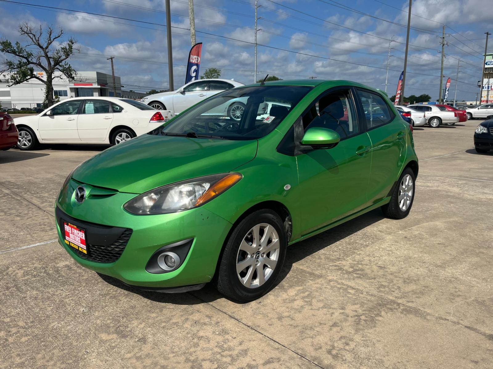 2013 green /black Mazda MAZDA2 Touring (JM1DE1LY1D0) with an 1.5L L4 DOHC 16V engine, Automatic transmission, located at 14700 Tomball Parkway 249, Houston, TX, 77086, (281) 444-2200, 29.928619, -95.504074 - Photo #2